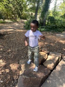 boy standing on rocks