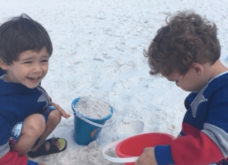 two preschool aged boys playing in the sand