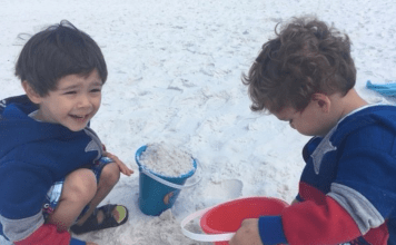 two preschool aged boys playing in the sand