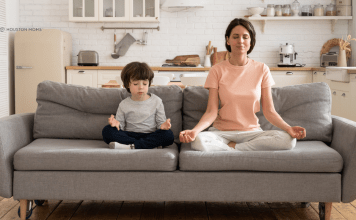 woman and son on couch practicing meditation