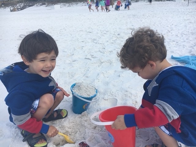 two preschool age boys playing in sand