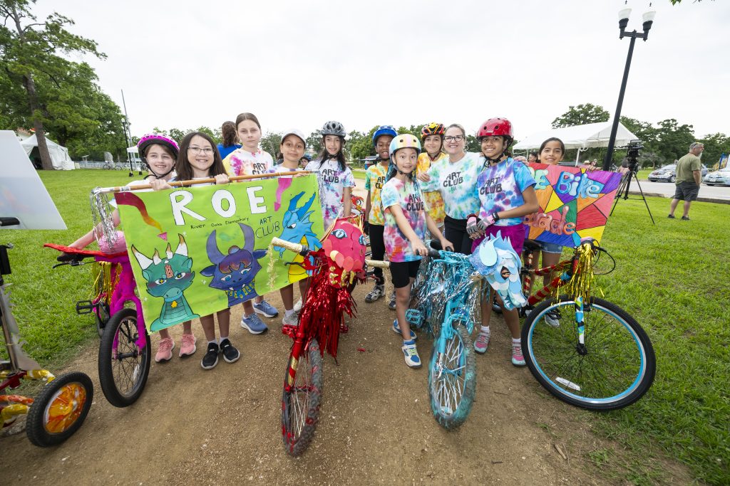 a group of Kids with colorfully decorated bikes and helmets helmets