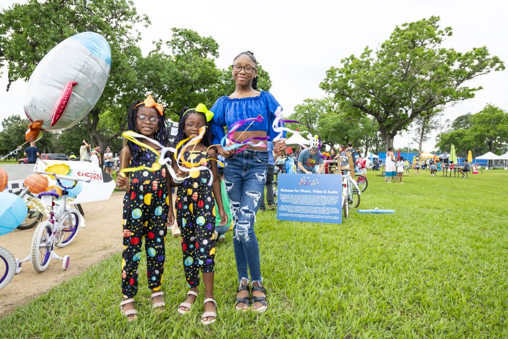 A family smiles at the bike parade