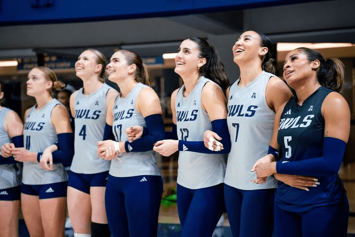 Rice University Athletes stand together smiling