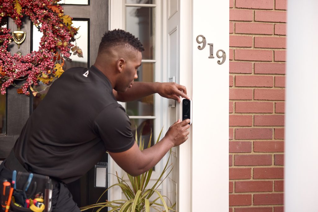 man installing doorbell