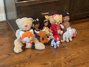 Group of stuffed animals on wood floor