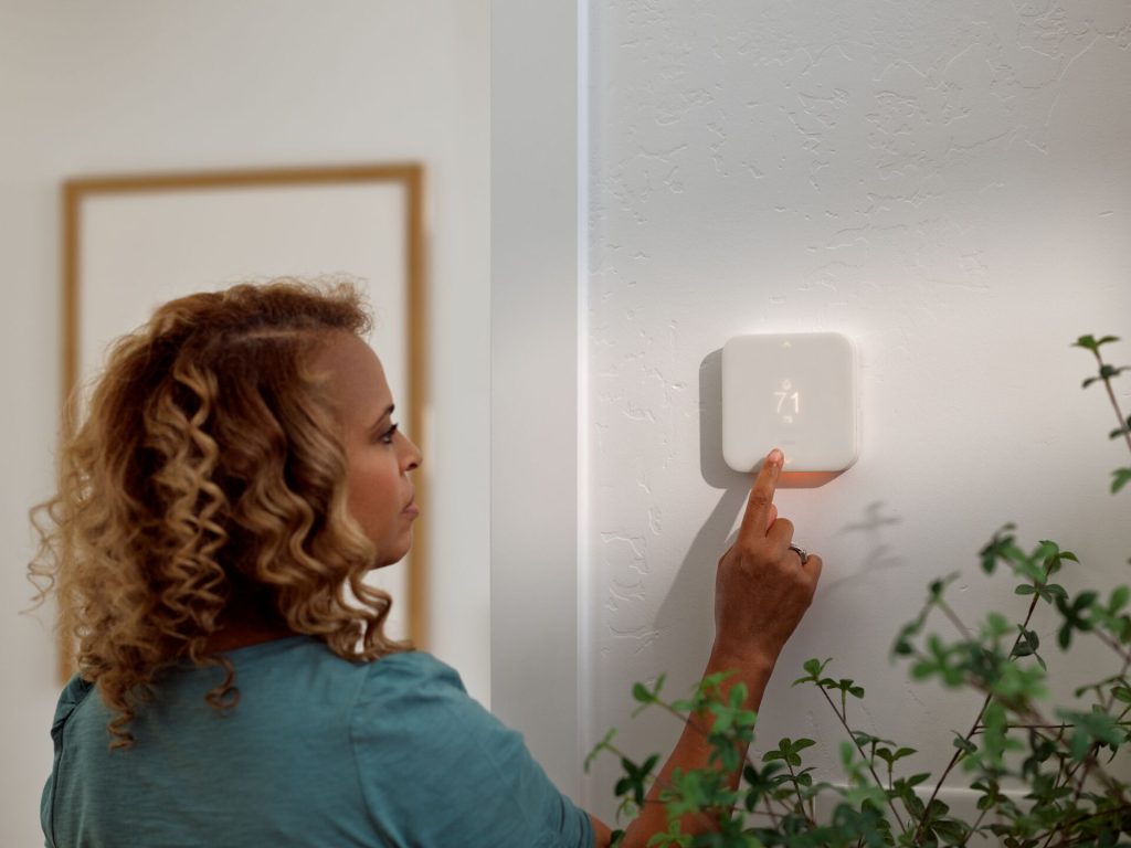 woman adjusting temperature