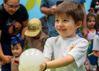 Make This Summer an Unforgettable Houston Adventure! A boy holds a smile bubble at the children's museum