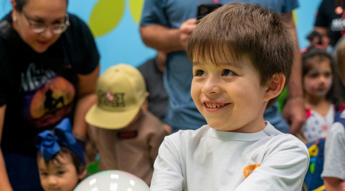 Make This Summer an Unforgettable Houston Adventure! A boy holds a smile bubble at the children's museum