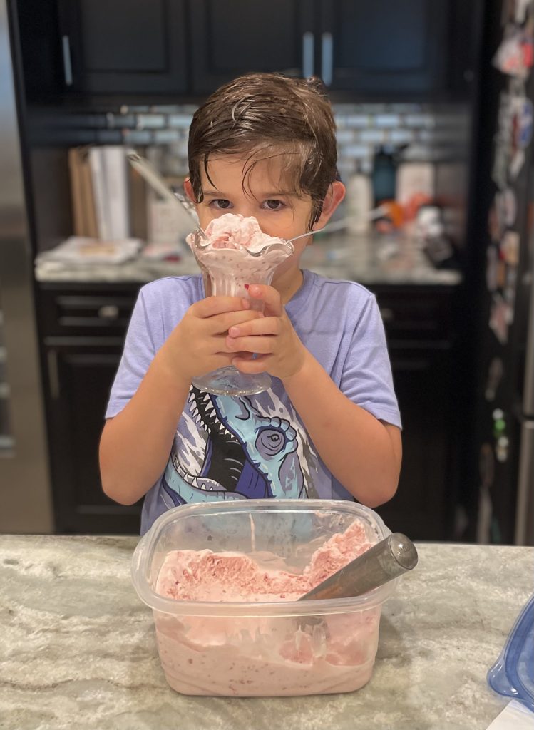 boy holding parfait glass of homemade ice cream