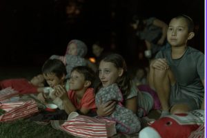 kids watching outdoor movies in Houston