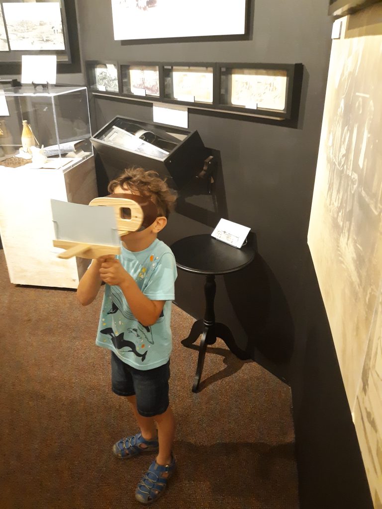 a child viewing an exhibit at the museum