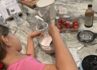 girl makes homemade ice cream on kitchen counter