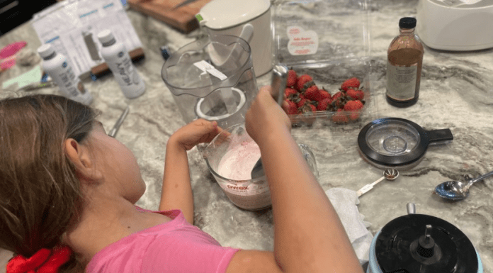 girl makes homemade ice cream on kitchen counter