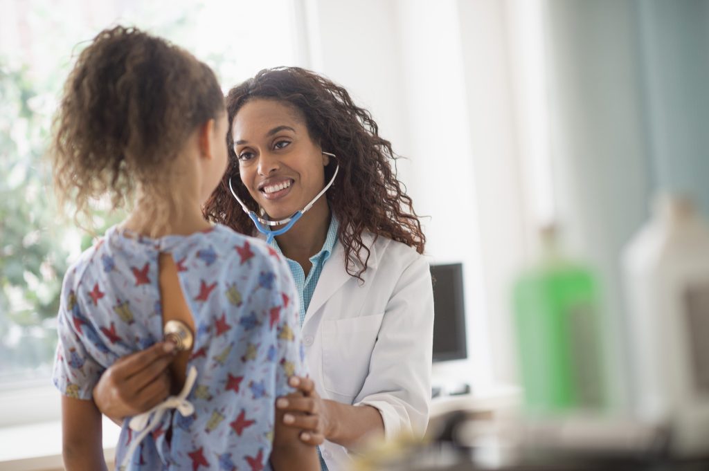 doctor listens to child patient with a stethoscope