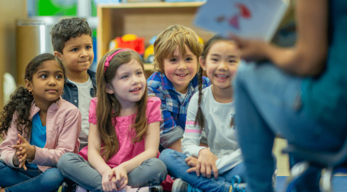 Why Waiting for Kindergarten was the Right Choice teacher reading to group of students sitting on floor