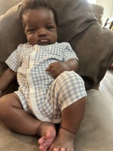 baby slouched on pillow
