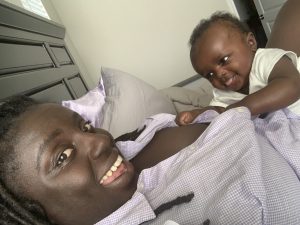 mother lying with smiling baby