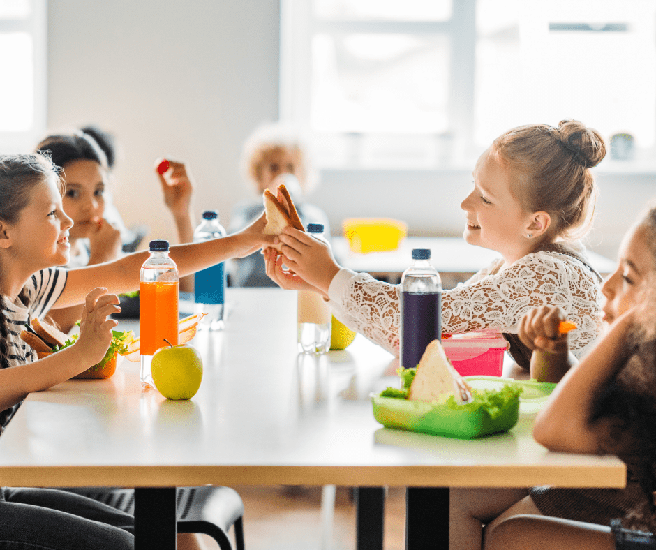 students sharing a sandwich at lunch