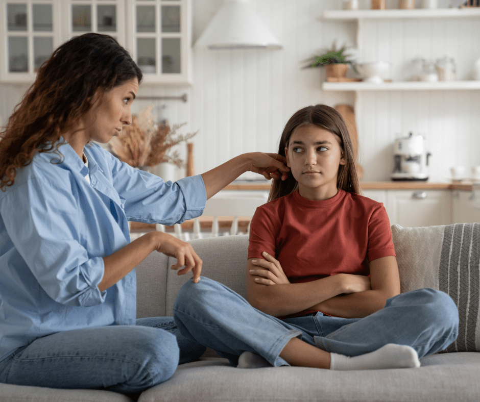 child and mother sit on the couch