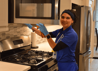 Why Busy Moms in Houston Swear by Professional Cleaning woman cleaning microwave