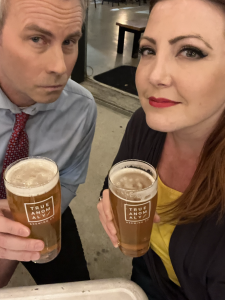 couple posing with glasses of beer