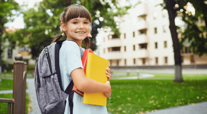 Back-to-School Hacks That Actually Make Life Easier girl with backpack on holding folders