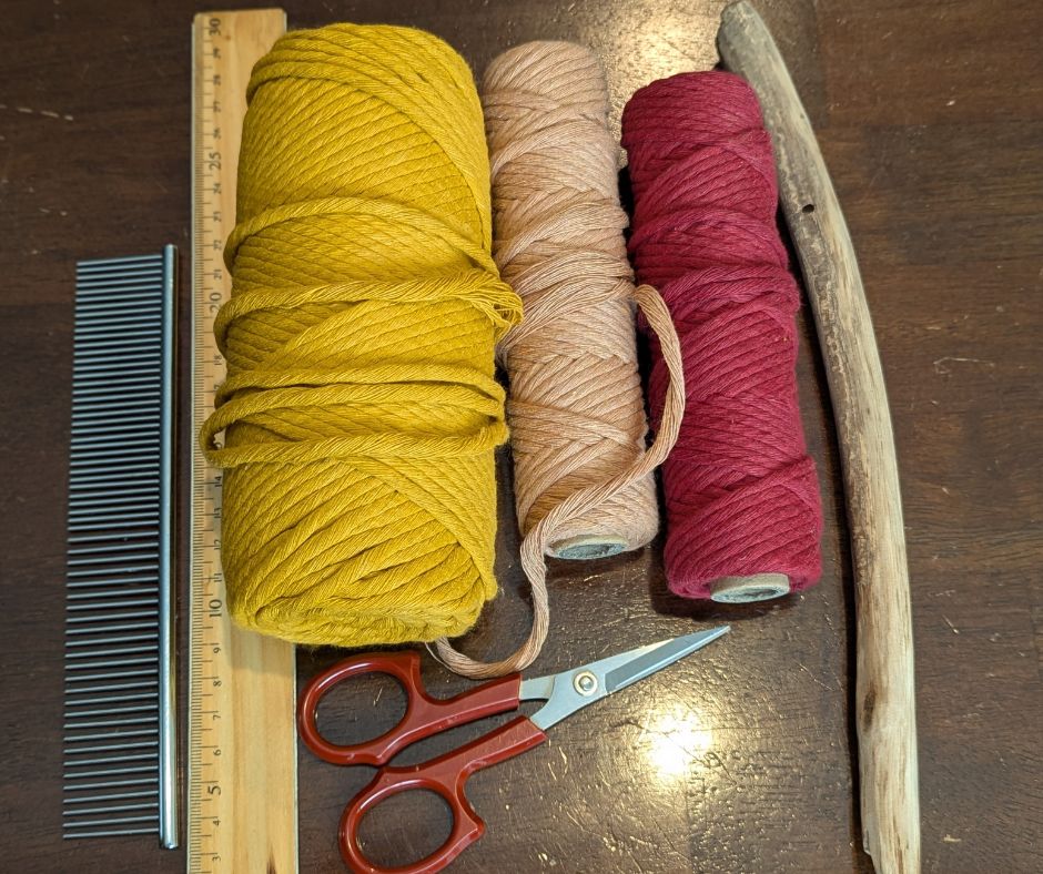 three spools of yarn, scissors, a stick and a ruler
