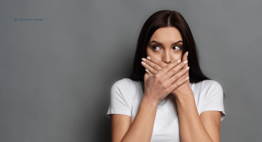 woman with hand over mouth