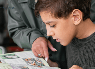 child reading with woman pointing to words