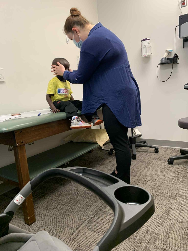 child being examined by a doctor