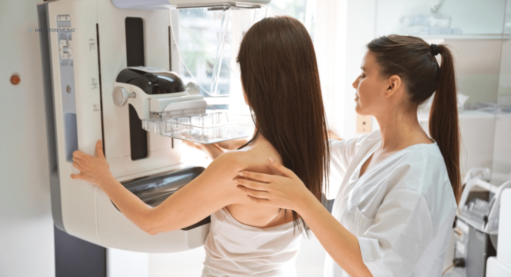nurse assists woman getting mammogram