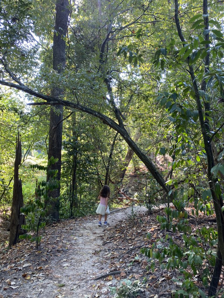 Girl walks through Edith Moore Nature Sanctuary