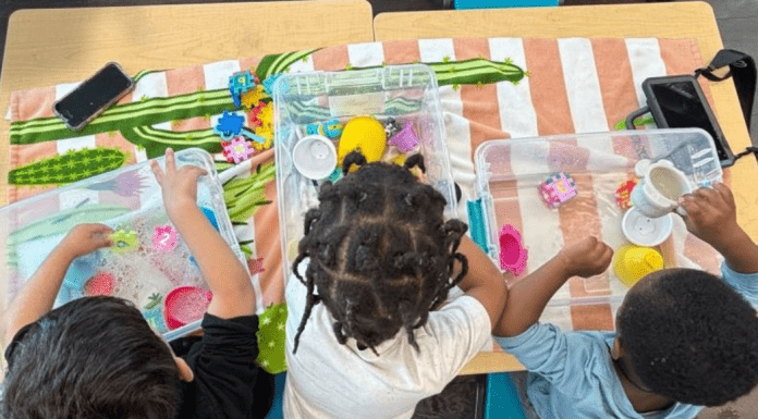 Houston Area ABA Therapy You Can Trust Children sitting at table playing with sensory bins