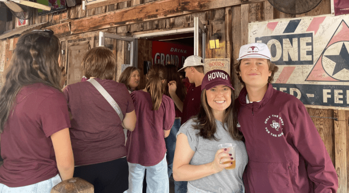 The Best Things to Do in College Station on Game Day mother and son stand in The Dixie Chicken in College Station