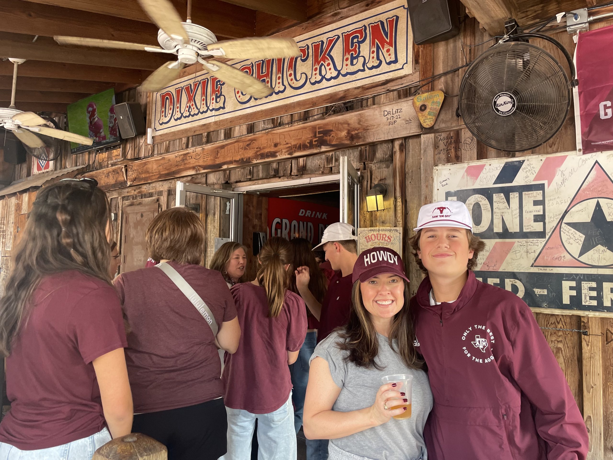 Mother and son stand in the Dixie Chicken in College Station