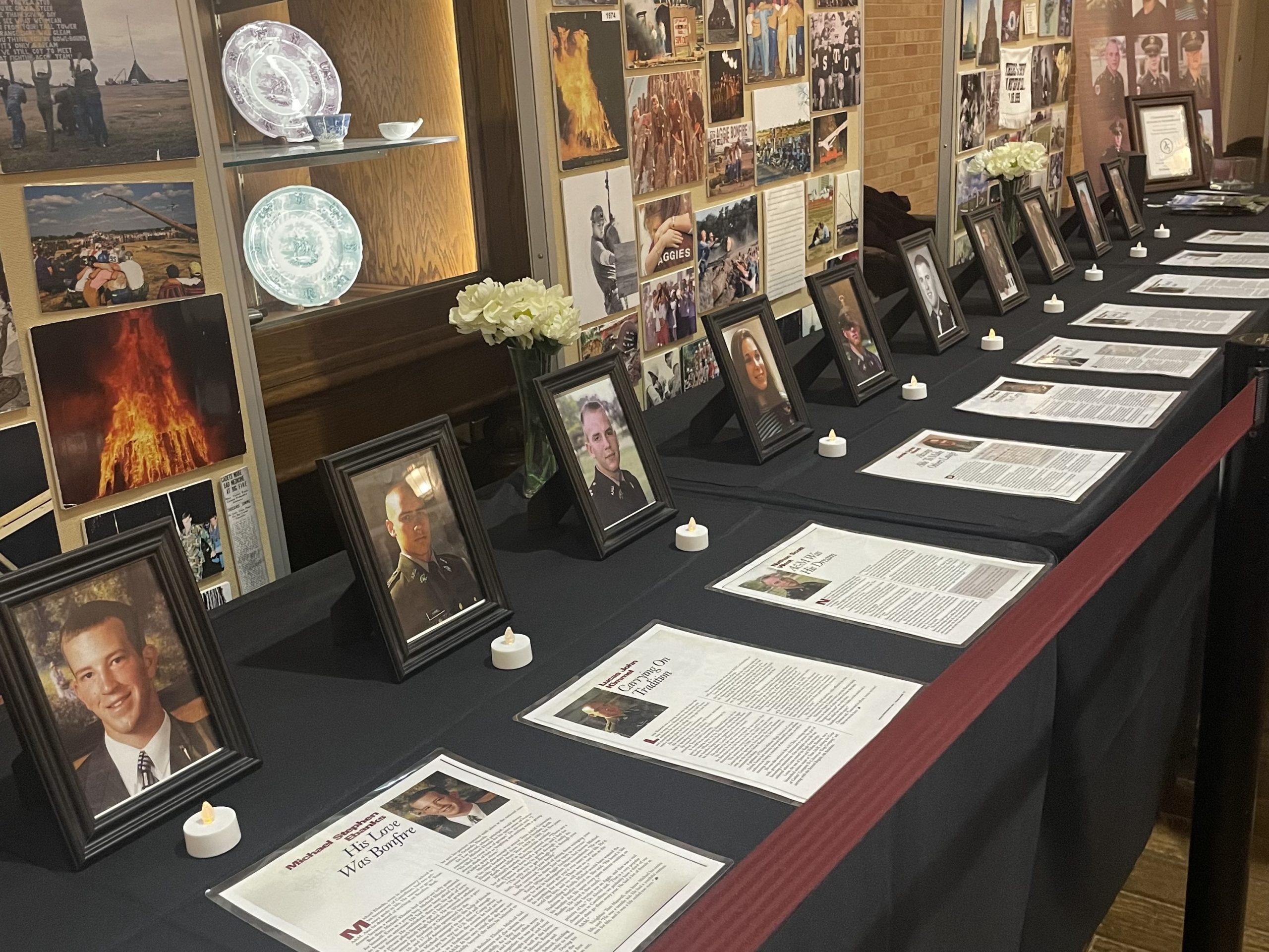 framed pictures of students with tea light candles in front of each one