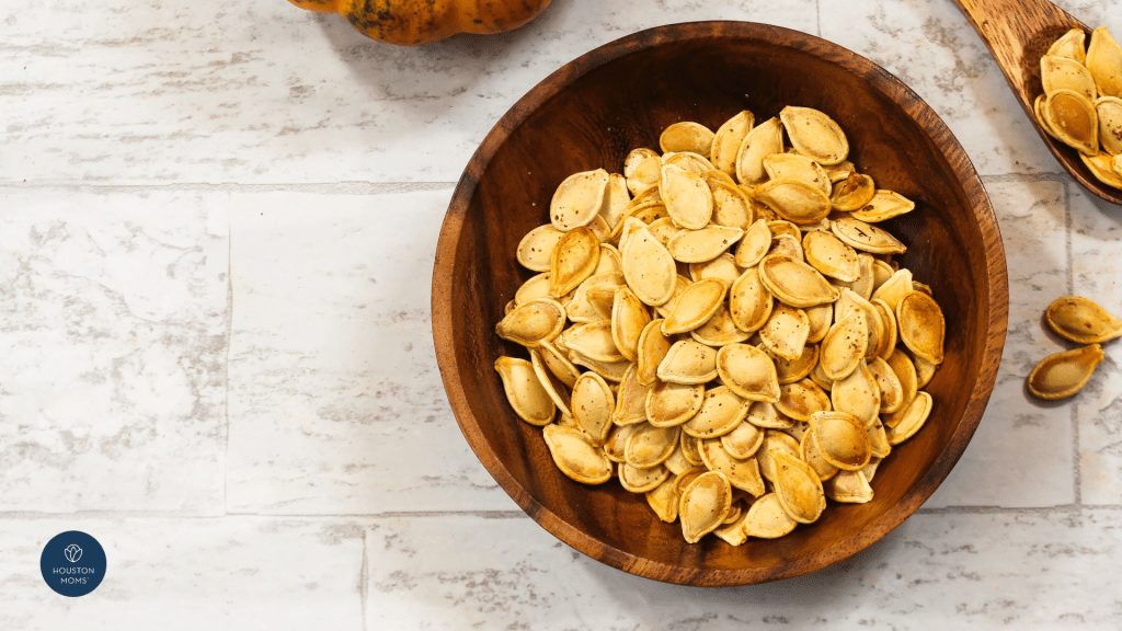 wooden bowl of roasted pumpkin seeds