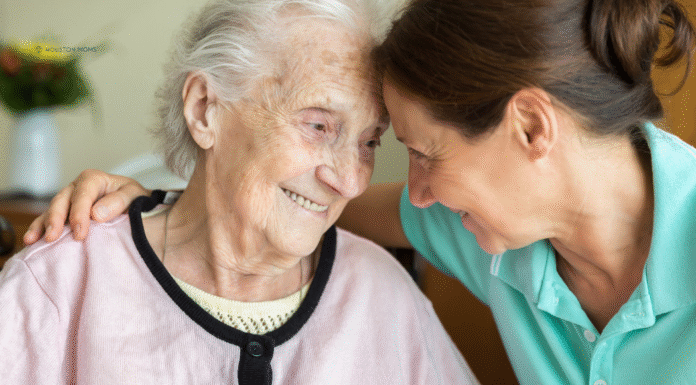 younger woman sits with younger woman with Alzheimer's