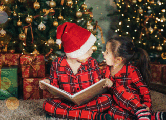 children reading holiday books under the Christmas tree
