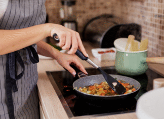 woman cooking stir fry in pan