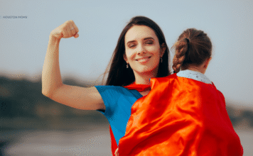 Please Don’t Call Me Supermom Mom holds child in cape