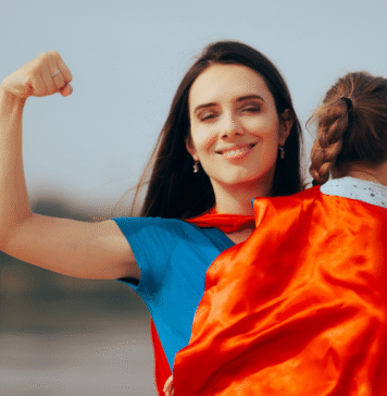 Please Don’t Call Me Supermom Mom holds child in cape