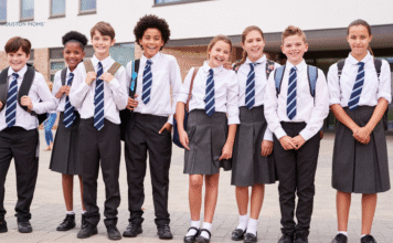 group of students in school uniforms stand in a row