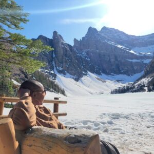 woman sitting outside gazing at mountains