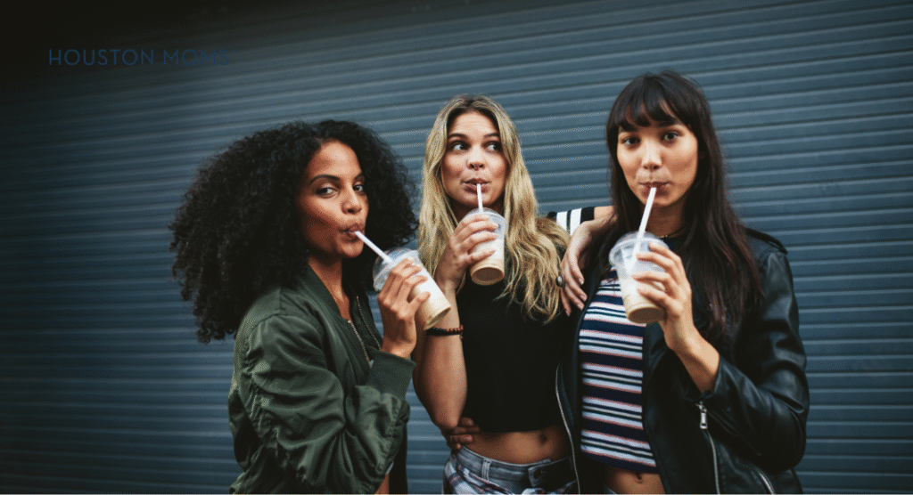 three women sipping drinks