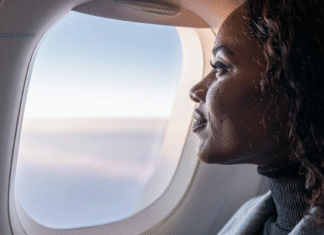 woman on airplane looking out window