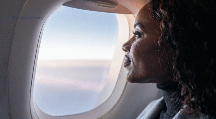woman on airplane looking out window