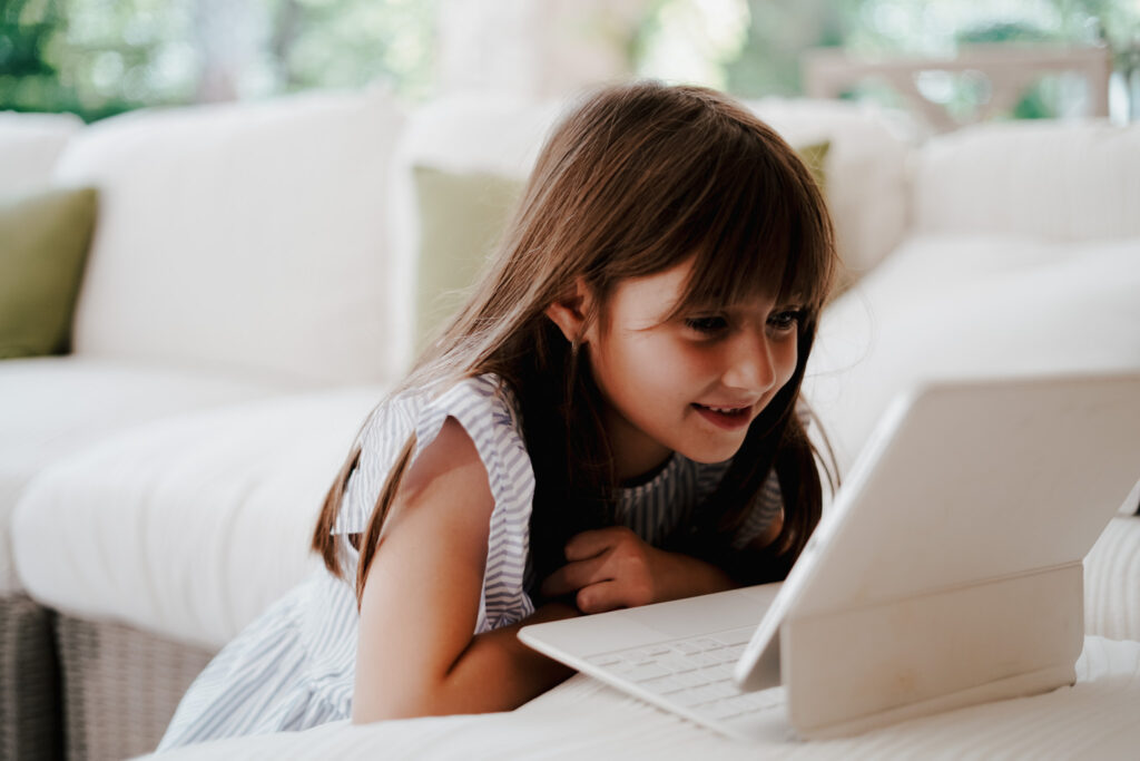 child doing live Spanish classes on tablet