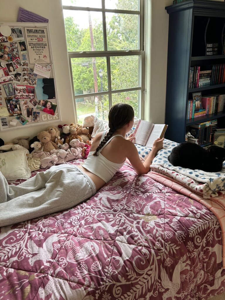 girl laying on bed reading